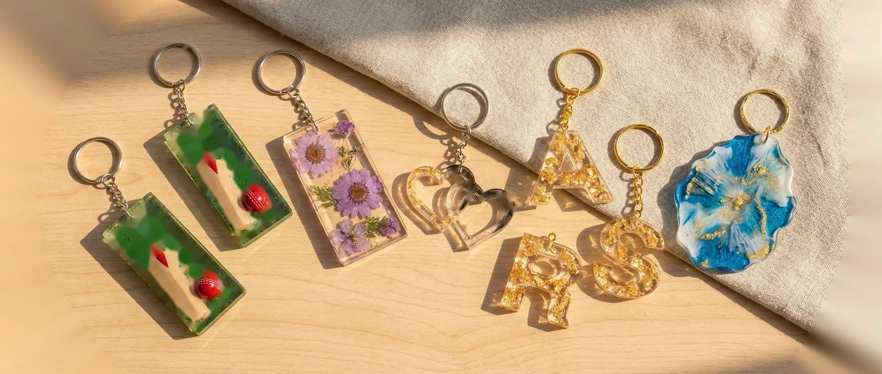 Flat lay of 6-8 mixed keychains showing variety. 800x280px